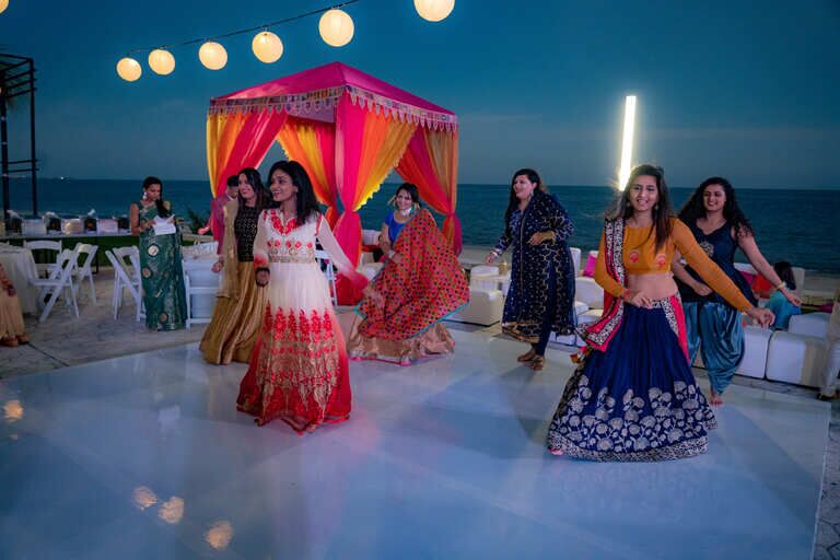 Ladies performing an exciting dance routine at a mehndi ceremony in Mexico on a hot, tropical, bright, summer day.