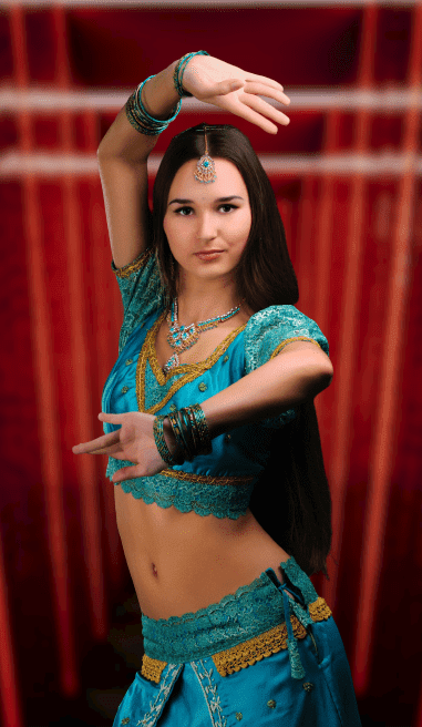 Girl performing a very intense belly dance routine in eccentric belly dance costumes.